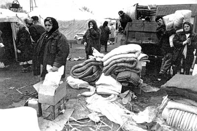 Memorial Society activists with humanitarian aid in the camps for refugees. Courtesy of the International Memorial Society.